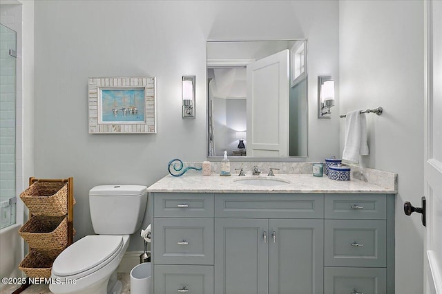 bathroom featuring a shower, vanity, and toilet