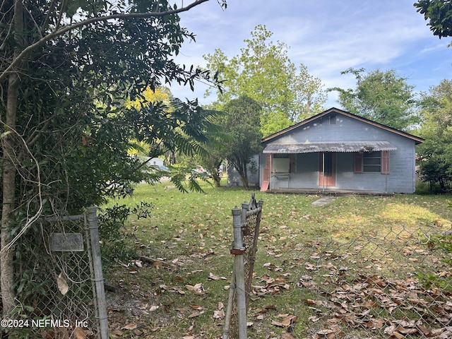 view of front of home featuring concrete block siding and a front yard