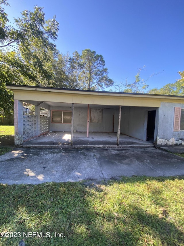 garage with driveway and a carport