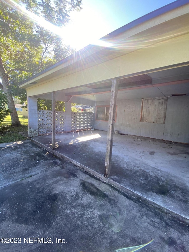 view of car parking featuring mail area and a carport