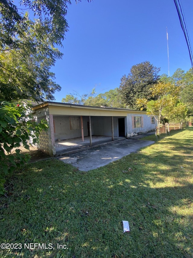 back of house featuring a yard and a patio