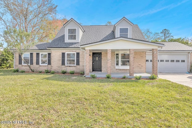 new england style home featuring a garage, a shingled roof, concrete driveway, a front yard, and brick siding