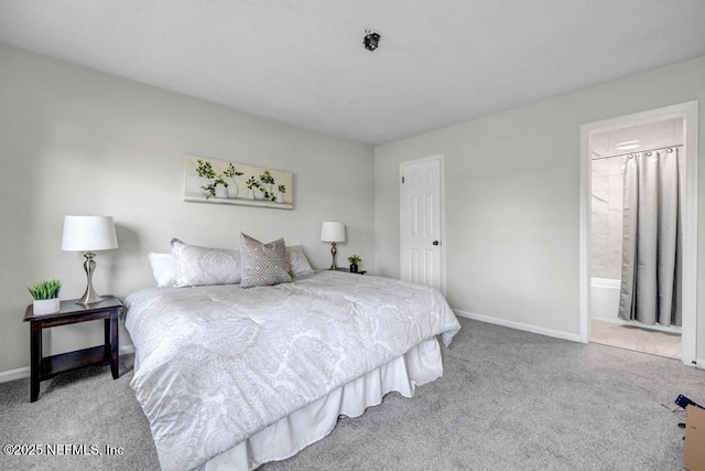 bedroom with ensuite bath, carpet, and baseboards