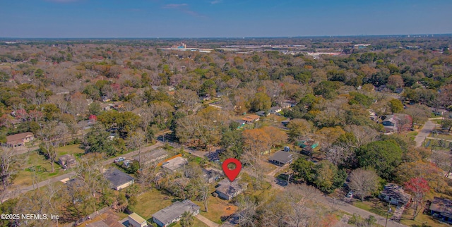 drone / aerial view featuring a forest view