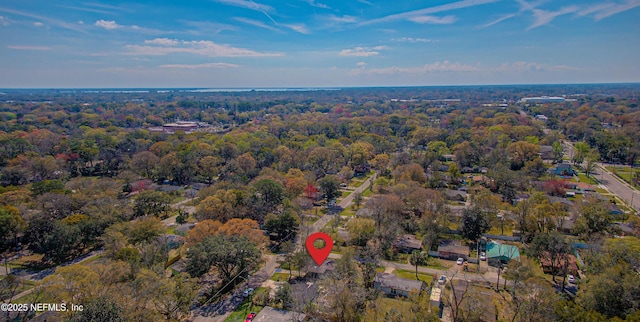 birds eye view of property with a view of trees