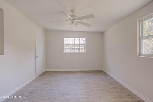 unfurnished room with ceiling fan, light wood-style flooring, and baseboards