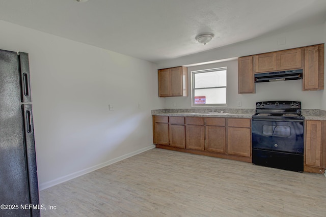 kitchen with black / electric stove, refrigerator, under cabinet range hood, a sink, and light wood-style floors