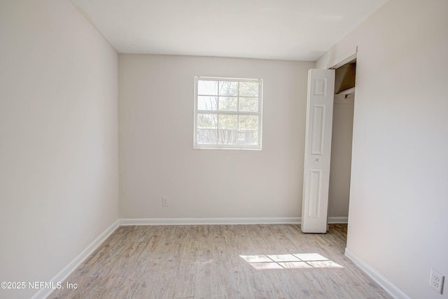 unfurnished bedroom featuring baseboards and wood finished floors