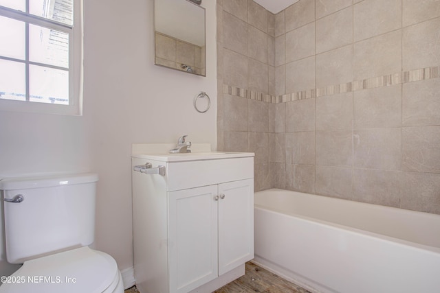 bathroom with shower / tub combination, vanity, toilet, and wood finished floors