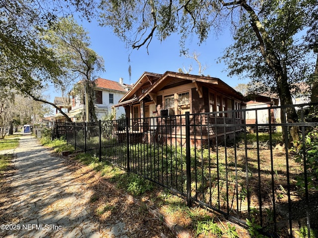 bungalow-style home with a fenced front yard