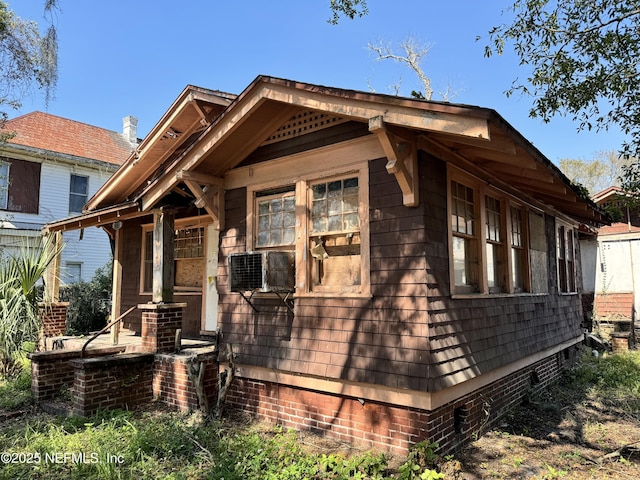 view of front facade with crawl space and cooling unit