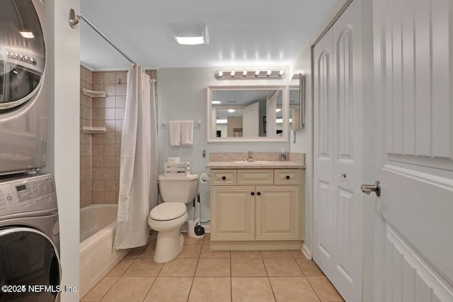 bathroom featuring toilet, vanity, stacked washer / drying machine, tile patterned floors, and shower / bath combination with curtain