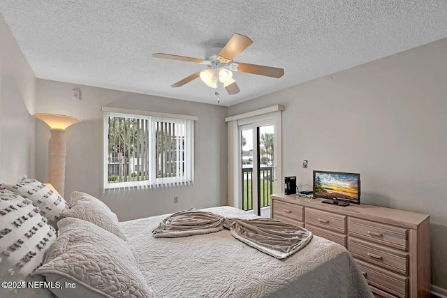 bedroom with access to outside, a textured ceiling, and a ceiling fan