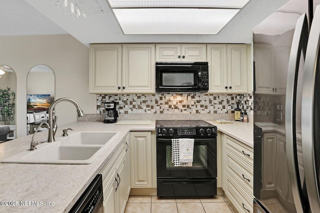 kitchen featuring black appliances, light countertops, a sink, and light tile patterned flooring