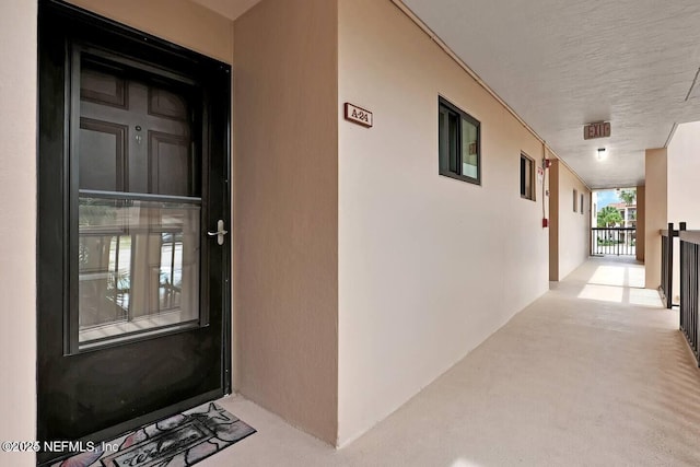 view of exterior entry with stucco siding