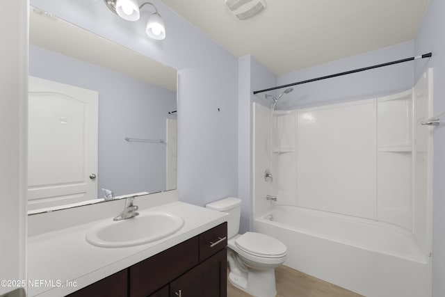 bathroom with visible vents, shower / washtub combination, toilet, wood finished floors, and vanity