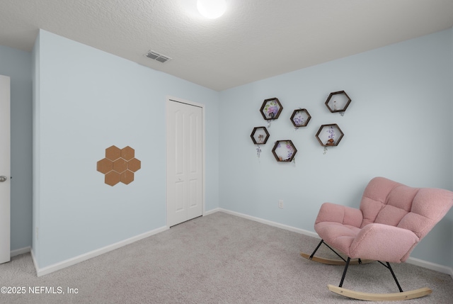 unfurnished room featuring carpet, visible vents, and baseboards