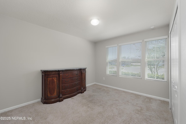 carpeted bedroom featuring baseboards