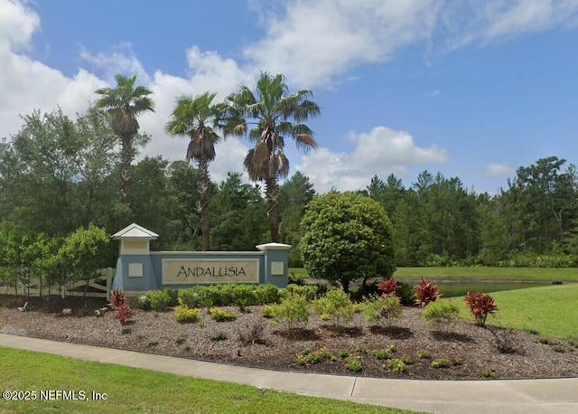 community / neighborhood sign with a yard