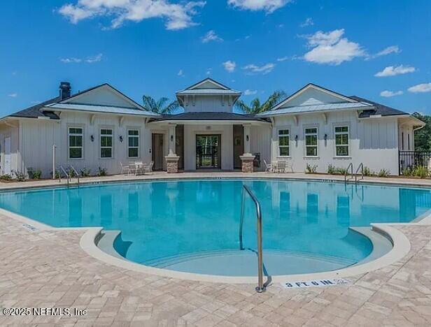 pool featuring a patio area and fence