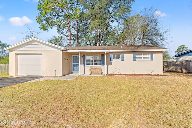 ranch-style home featuring a garage, aphalt driveway, fence, a front lawn, and stucco siding