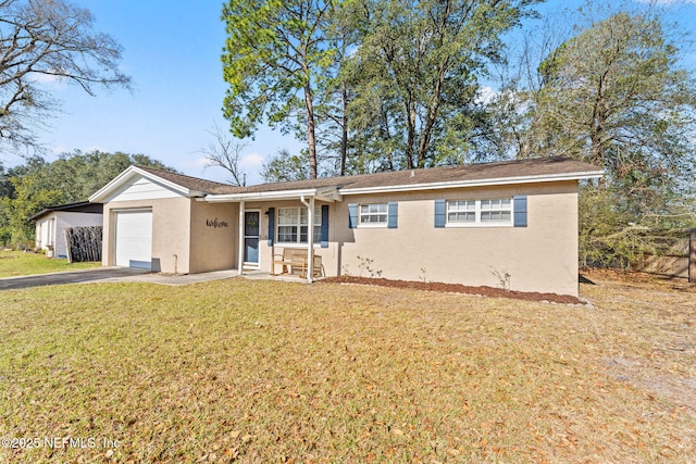 ranch-style house with a front lawn, driveway, an attached garage, and stucco siding