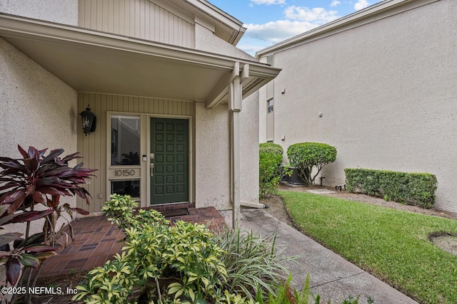 doorway to property with stucco siding