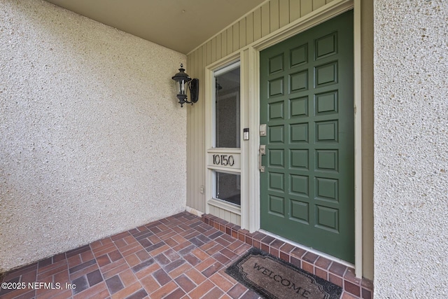 doorway to property with stucco siding