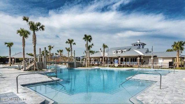 pool with fence and a patio