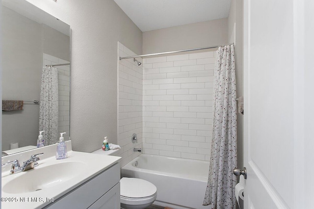 bathroom with a textured wall, shower / bathtub combination with curtain, toilet, and vanity