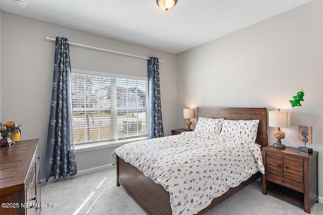 bedroom with baseboards, multiple windows, and light colored carpet