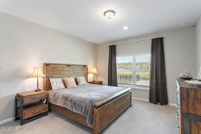 bedroom with light carpet and baseboards