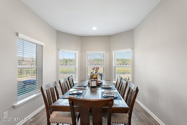 dining room featuring wood finished floors and baseboards