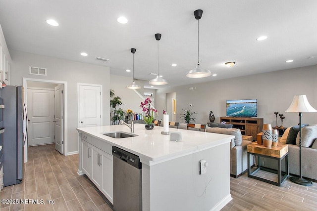 kitchen featuring a sink, visible vents, white cabinets, appliances with stainless steel finishes, and wood tiled floor