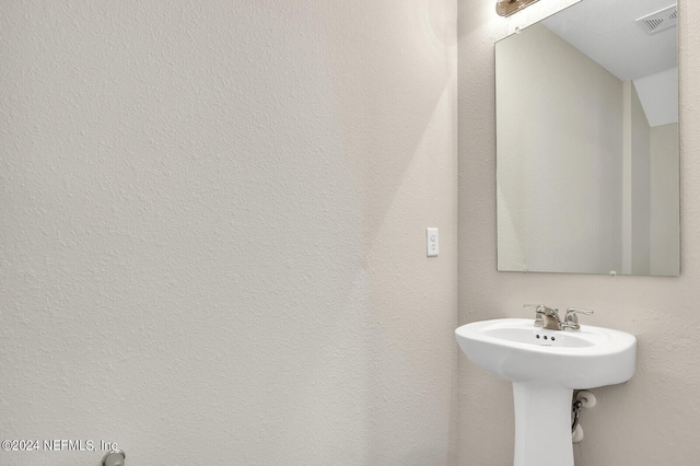 bathroom with a sink and visible vents