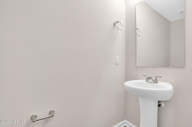 bathroom with visible vents and a sink