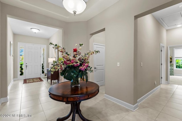 foyer entrance featuring light tile patterned floors and baseboards