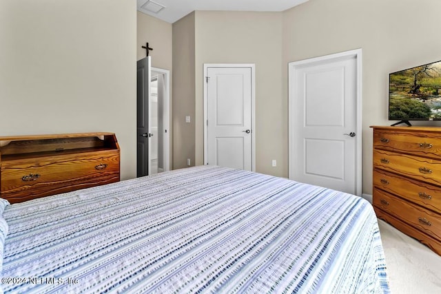 carpeted bedroom featuring visible vents