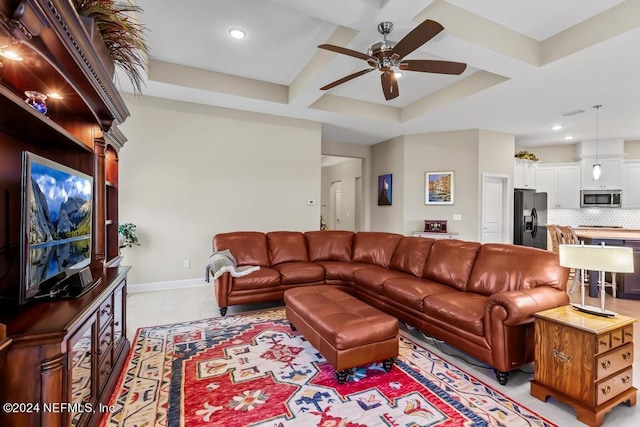 living area featuring light tile patterned floors, coffered ceiling, a ceiling fan, baseboards, and beamed ceiling