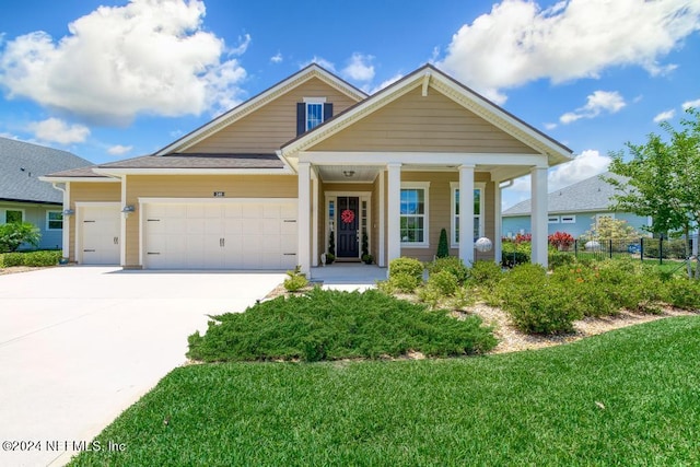 view of front of home with a garage, driveway, a front lawn, and fence