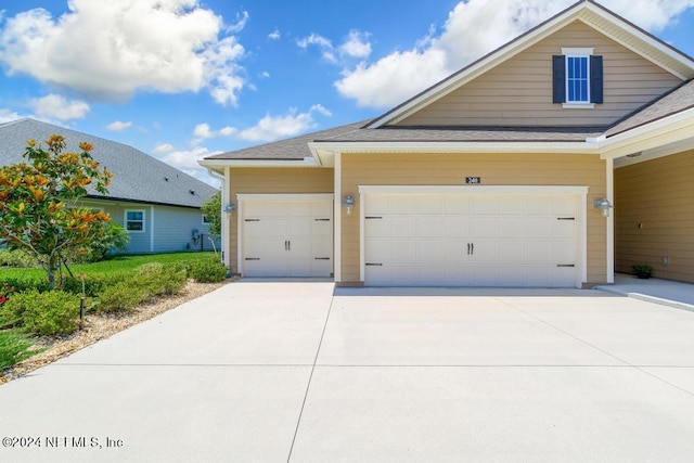 view of front of house with concrete driveway and an attached garage