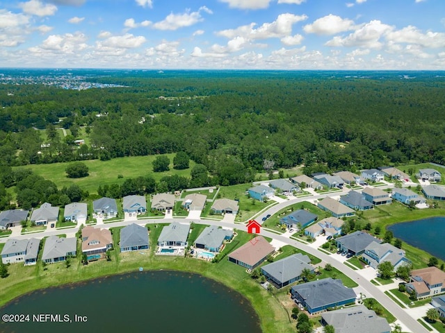 bird's eye view featuring a water view, a forest view, and a residential view