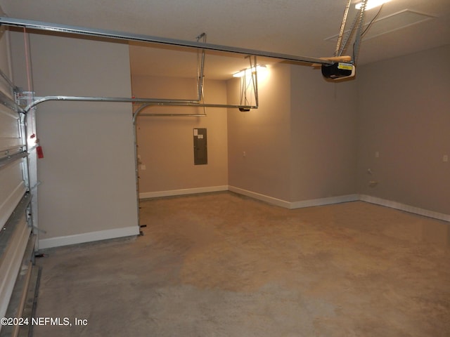 garage featuring baseboards, electric panel, and a garage door opener