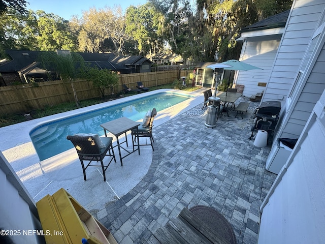 view of swimming pool featuring a fenced in pool, a patio area, and a fenced backyard