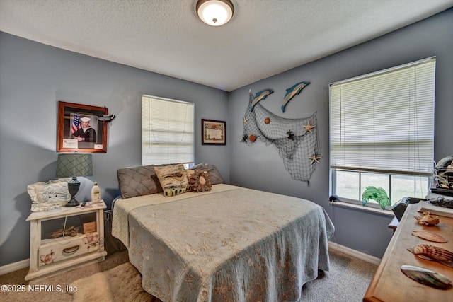 carpeted bedroom featuring baseboards and a textured ceiling