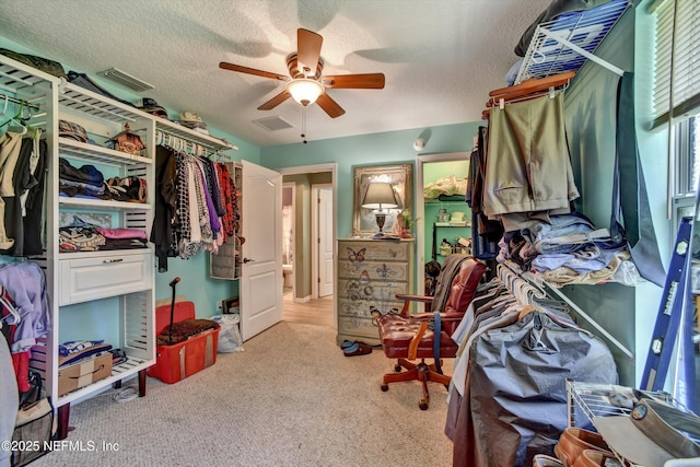 walk in closet featuring a ceiling fan, carpet, and visible vents