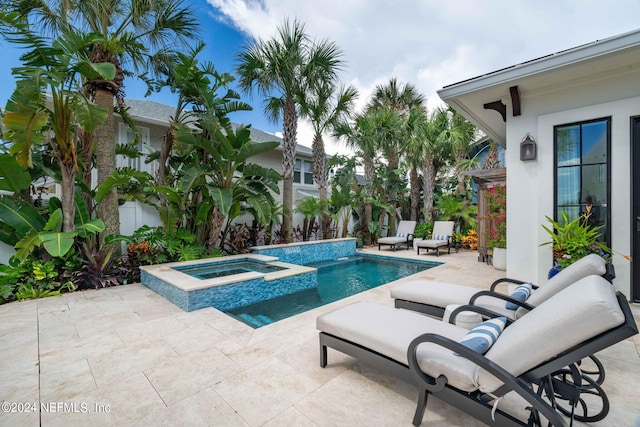 view of swimming pool with a pool with connected hot tub and a patio