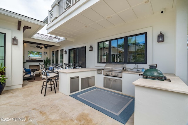 view of patio / terrace with a balcony, a grill, exterior kitchen, outdoor wet bar, and a sink