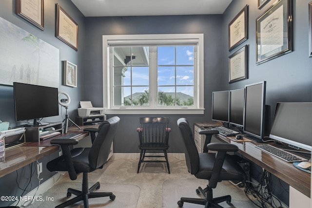 home office featuring light colored carpet and baseboards