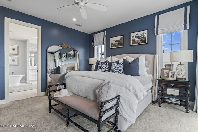 carpeted bedroom featuring a ceiling fan, tile patterned flooring, visible vents, and connected bathroom